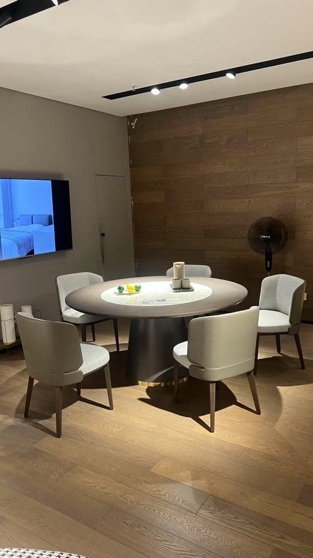 Round dining table with upholstered chairs